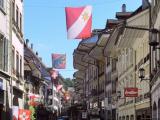 Thun, Obere Hauptgasse, shops on two levels. Flags of Thun, Bern and Switzerland Thun, Obere Hauptgasse, shops on two levels. Flags of Thun, Bern and Switzerland