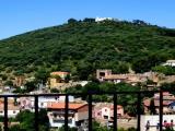 Iglesias: Vista di parte delle mura e delle torri pisane. In alto Santuario della Madonna del Buoncammino