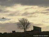 Outhouse, shed at Gimra, Rege. Plane in for landing