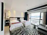 A Double Room With A Large Floor-to-ceiling Window And A Full River View.