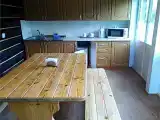 Номер в деревянном домике с  одной 2-спальной и одной 1-спальной кроватью и кухней