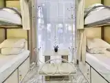 Кровать в общем женском номере с трехъярусными кроватями №1 (удобства на этаже)